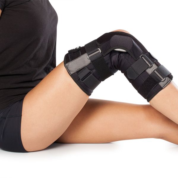 Wraparound range of motion hinged knee brace